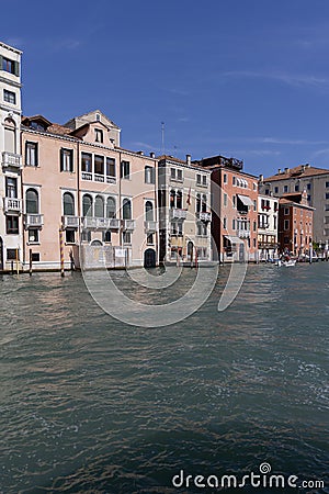 Grand Canal, historic decorative tenement houses, floating boats, Venice, Italy Editorial Stock Photo