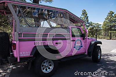 Grand Canyon, Arizona: A famous Pink Jeep Tours vehicle sits in the shade at a viewpoint along the South Rim of the Editorial Stock Photo