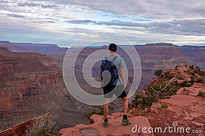 Grand Canyon - Man with panoramic aerial view from Ooh Ahh point on South Kaibab hiking trail at South Rim, Arizona, USA Stock Photo