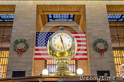 Grand Centralâ€™s Main Concourse Clock in New York. Famous Golden Structure. United States of America Flag in Background Editorial Stock Photo