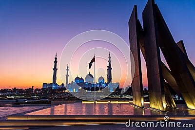 Grand Mosque in Abu Dhabi and Wahat al Karama monument after sunset Stock Photo
