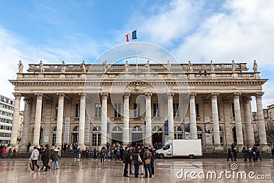 Grand Theatre of Bordeaux taken during a sunny afternoon with a French flag waiving Editorial Stock Photo