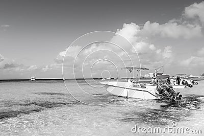 Grand Turk, Turks and Caicos Islands - December 29, 2015: motor boats and people on sea beach. Powerboats on sunny Editorial Stock Photo