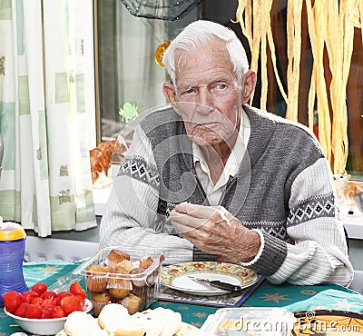 Elderly man eating Stock Photo