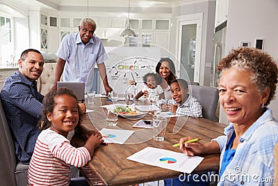 Grandad presenting a home meeting, family looking to camera Stock Photo