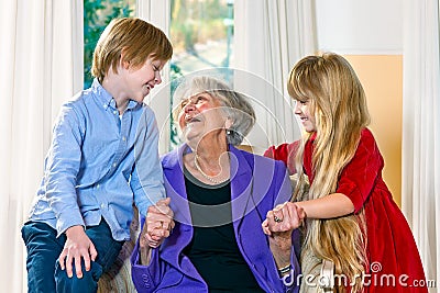 Grandchildren visiting their elderly grandmother Stock Photo