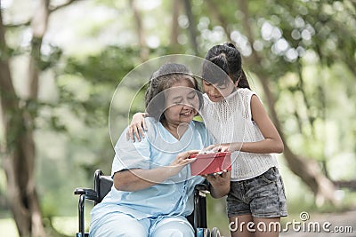Granddaughter have surprise to grandmother sitting Stock Photo