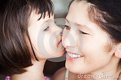 Granddaughter kissing grandmother, Family picture Stock Photo