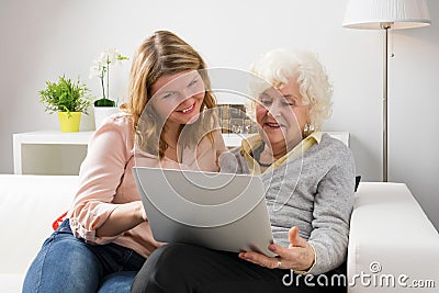 Granddaughter teaching grandma how to use computer Stock Photo