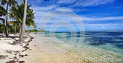 People taking ocean bath on the beautiful beach of Petit Havre beach in south on Grande-Terre on Guadeloupe island Editorial Stock Photo