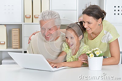Grandfather, daughter and granddaughter using laptop Stock Photo