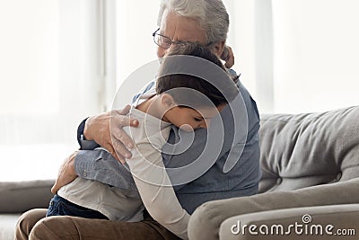 Grandfather embraces grandchild enjoy moment of caress and tenderness Stock Photo