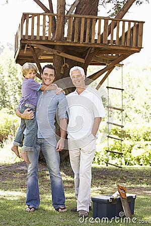 Grandfather, Father And Son Building Tree House Together Stock Photo