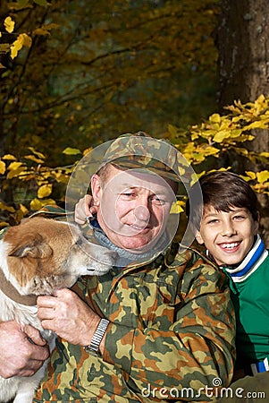 Grandfather, grandson and dog Stock Photo