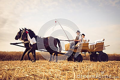 Grandfather and grandson riding in carriage wearing traditional costume in Vojvodina, Serbia Editorial Stock Photo