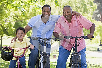 Grandfather grandson and son bike riding Stock Photo