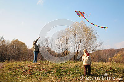 Grandfather and grandson start kite Stock Photo