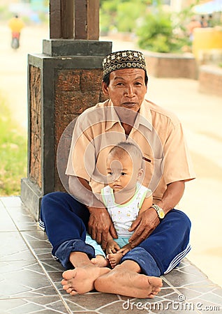 Grandfather holding a baby Editorial Stock Photo