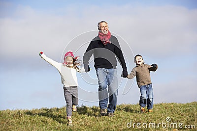 Grandfather Holding Hands With His Grandchildren Stock Photo