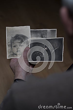 Grandfather holding old family pictures Stock Photo