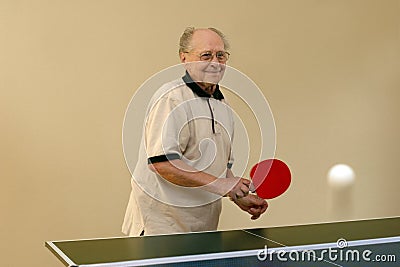 Grandfather playing ping pong Stock Photo