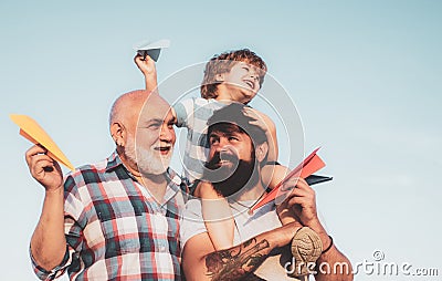 Grandfather with son and grandson having fun in park. Fathers day concept. Cute child hugging his father and grandfather Stock Photo
