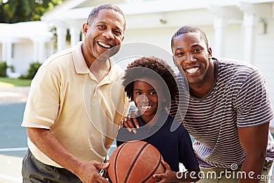 Grandfather With Son And Grandson Playing Basketball Stock Photo