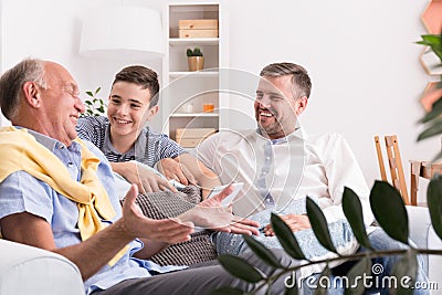 Grandfather telling story to son Stock Photo