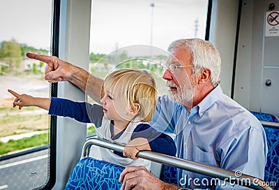 Grandfather and Grandson Spend Time Together on Train Stock Photo