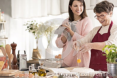 Grandma cracking an egg Stock Photo