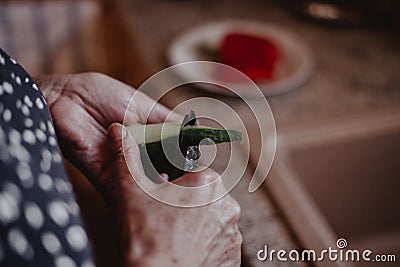 Grandma cutting healthy vegetables in kitchen Stock Photo