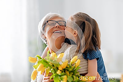 Grandma and girl smiling and hugging Stock Photo