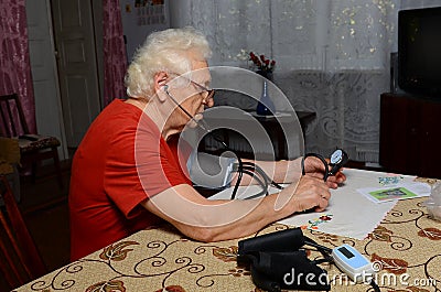 Grandma measures the pressure Stock Photo