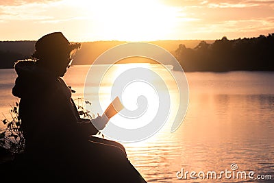 Grandma read a book in nature. Stock Photo