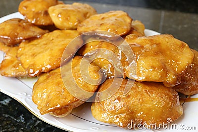 Grandmother cakes a homemade sweet fried with honey