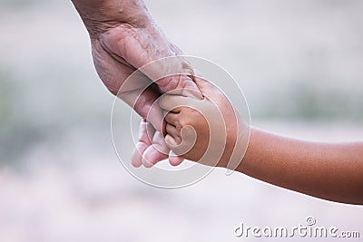 Grandmother and child little girl holding hand together Stock Photo