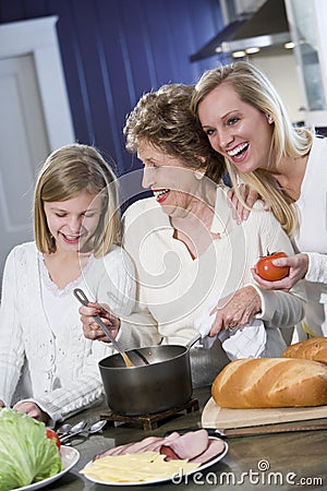 Grandmother with family cooking in kitchen Stock Photo