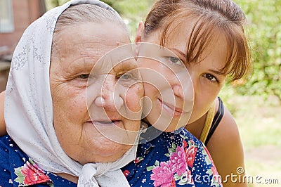 Grandmother and granddaughter embraced and happy Stock Photo