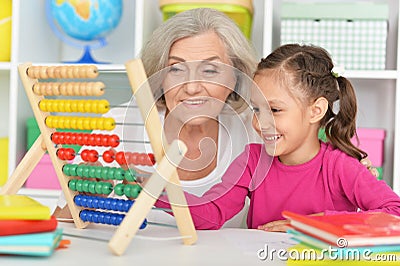 Grandmother and granddaughter learning to use abacus Stock Photo