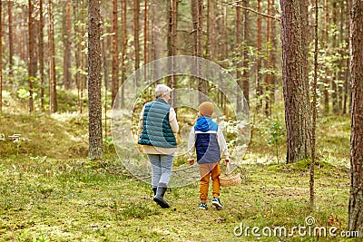 grandmother and grandson with baskets in forest Stock Photo