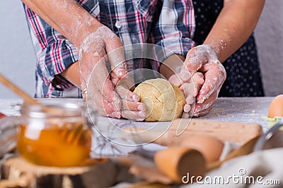 Grandmother with grandson cooking, kneading dough, baking in the kitchen Stock Photo