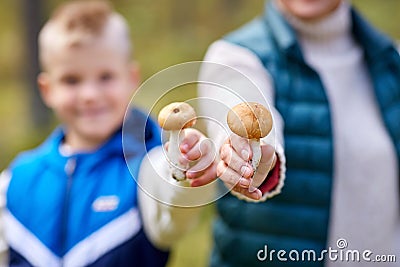 grandmother and grandson with mushrooms in forest Stock Photo