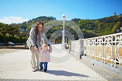 Grandmother helping granddaughter make her firts steps Stock Photo