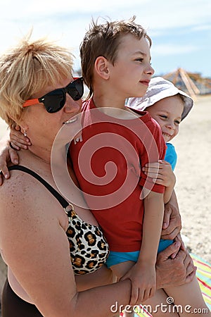 Grandmother hugging her grandsons Stock Photo