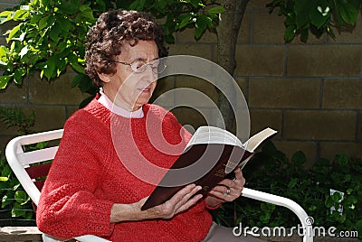 Grandmother Reads Bible Stock Photo