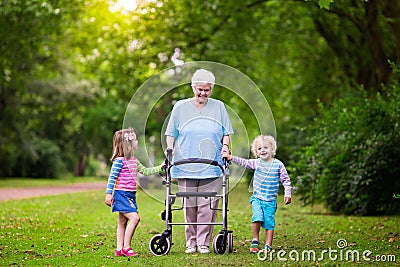 Grandmother with walker playing with two kids Stock Photo