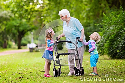 Grandmother with walker playing with two kids Stock Photo