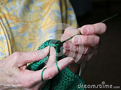 Grandmothers hands crochet green yarn. Closeup clip of senior woman crocheting Stock Photo