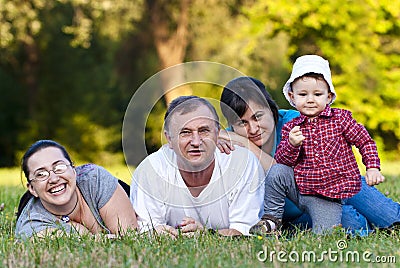 Grandpa, daughters and niece on grass Stock Photo