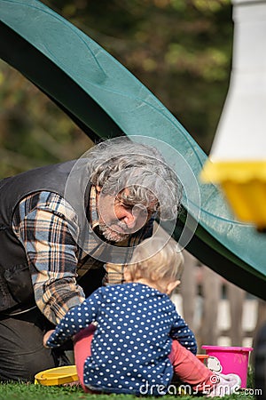 Grandpa and granddaughter playing Stock Photo